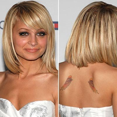  angel wings on her back and a rosary wrapped around her ankle Nicole 